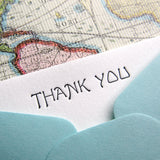 Letterpress thank you stationery, blue envelopes, greeting monotone font in black ink on pearl cotton cards with lined envelopes; made by inviting letterpress in austin, texas.