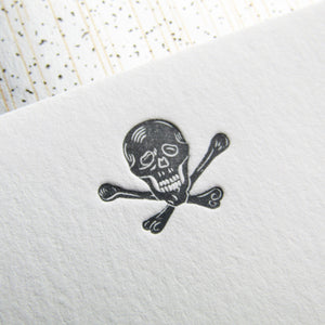 Letterpress skull stationery, printed in gray ink onto white cards, with gray envelopes, lined with speckled papers. By inviting.