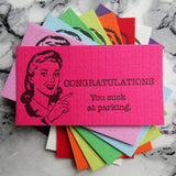 Letterpress bad parking cards with retro lady "Congratulations You Suck at Parking!" by inviting in Austin, Texas.